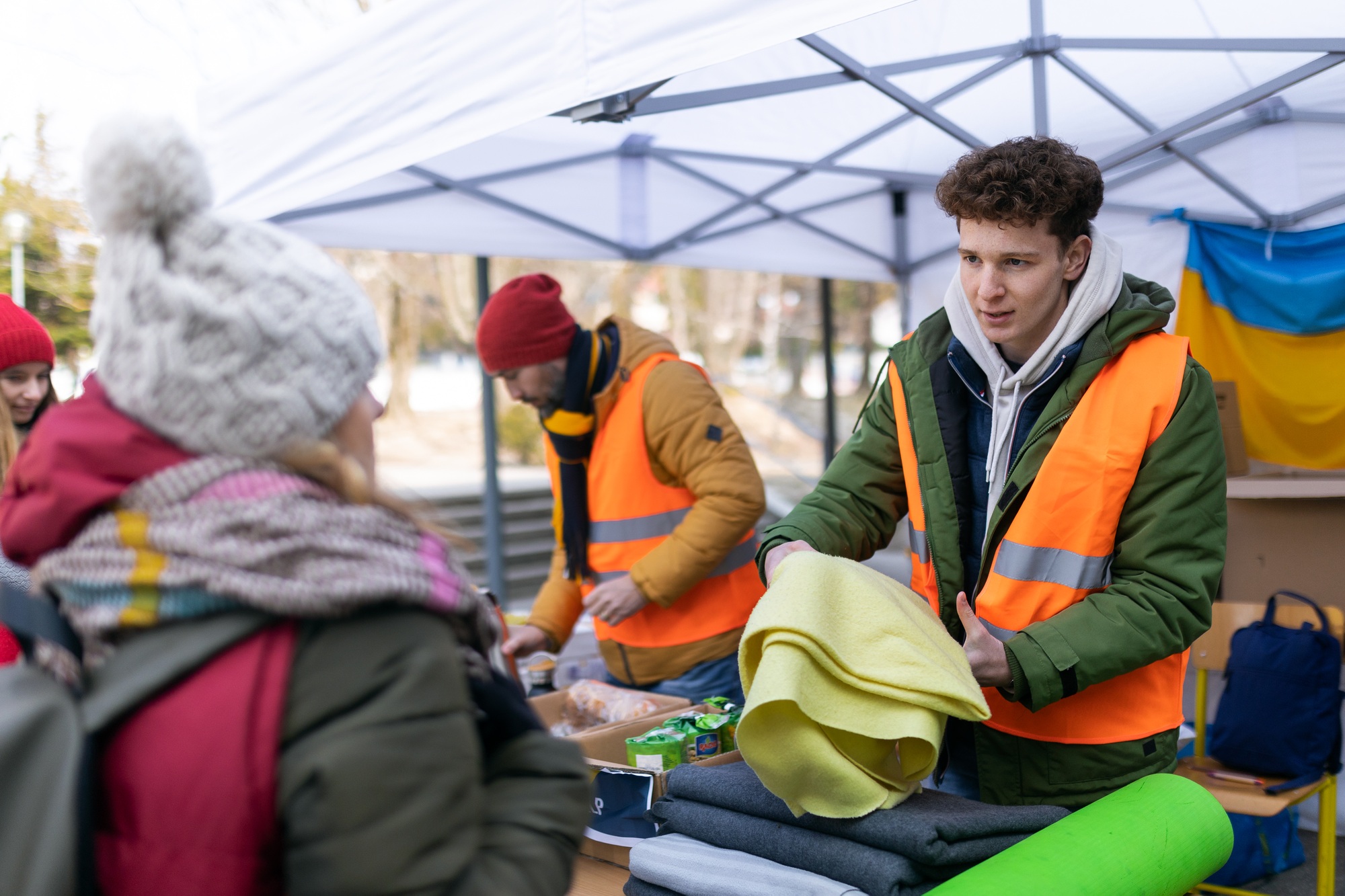 Volunteers distributing blankets and other donations to refugees on the Ukrainian border