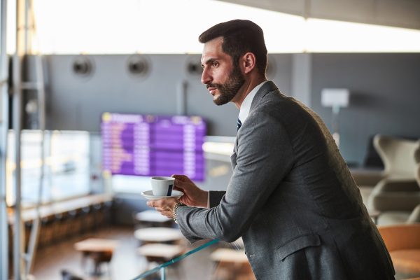 Business executive searching for someone from the stair top